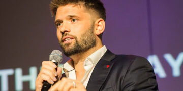 Matthew Thayer speaking on stage