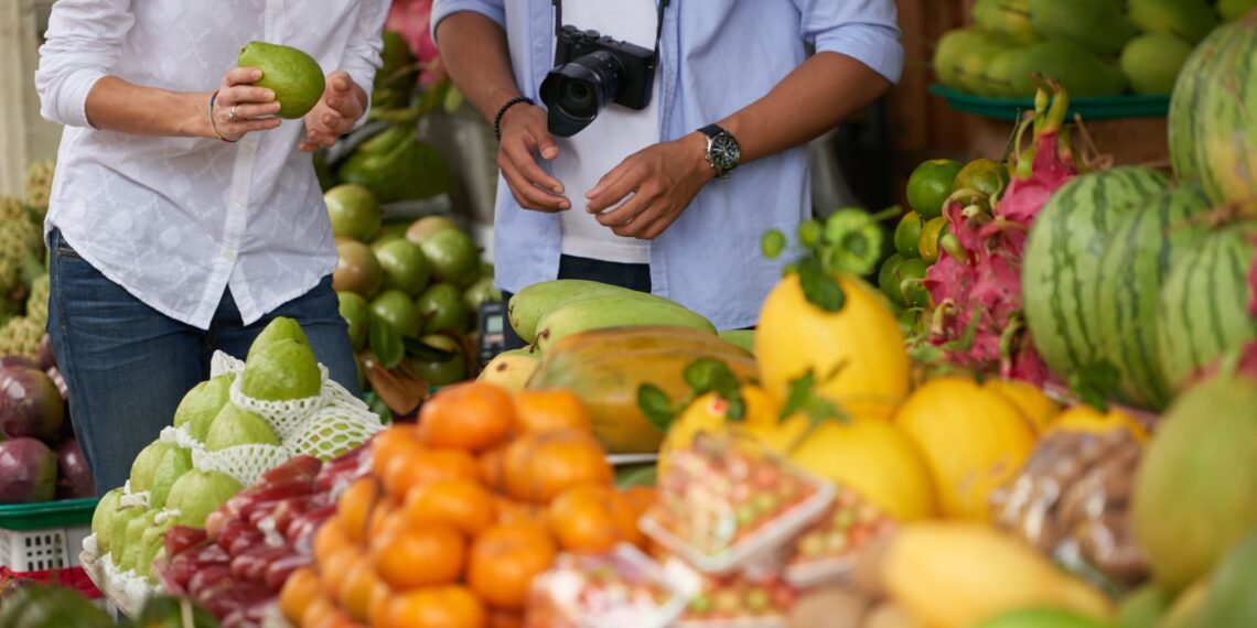 tourist couple choosing fruits