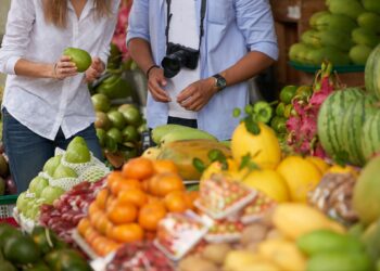 tourist couple choosing fruits