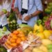 tourist couple choosing fruits