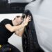 man inspecting a car